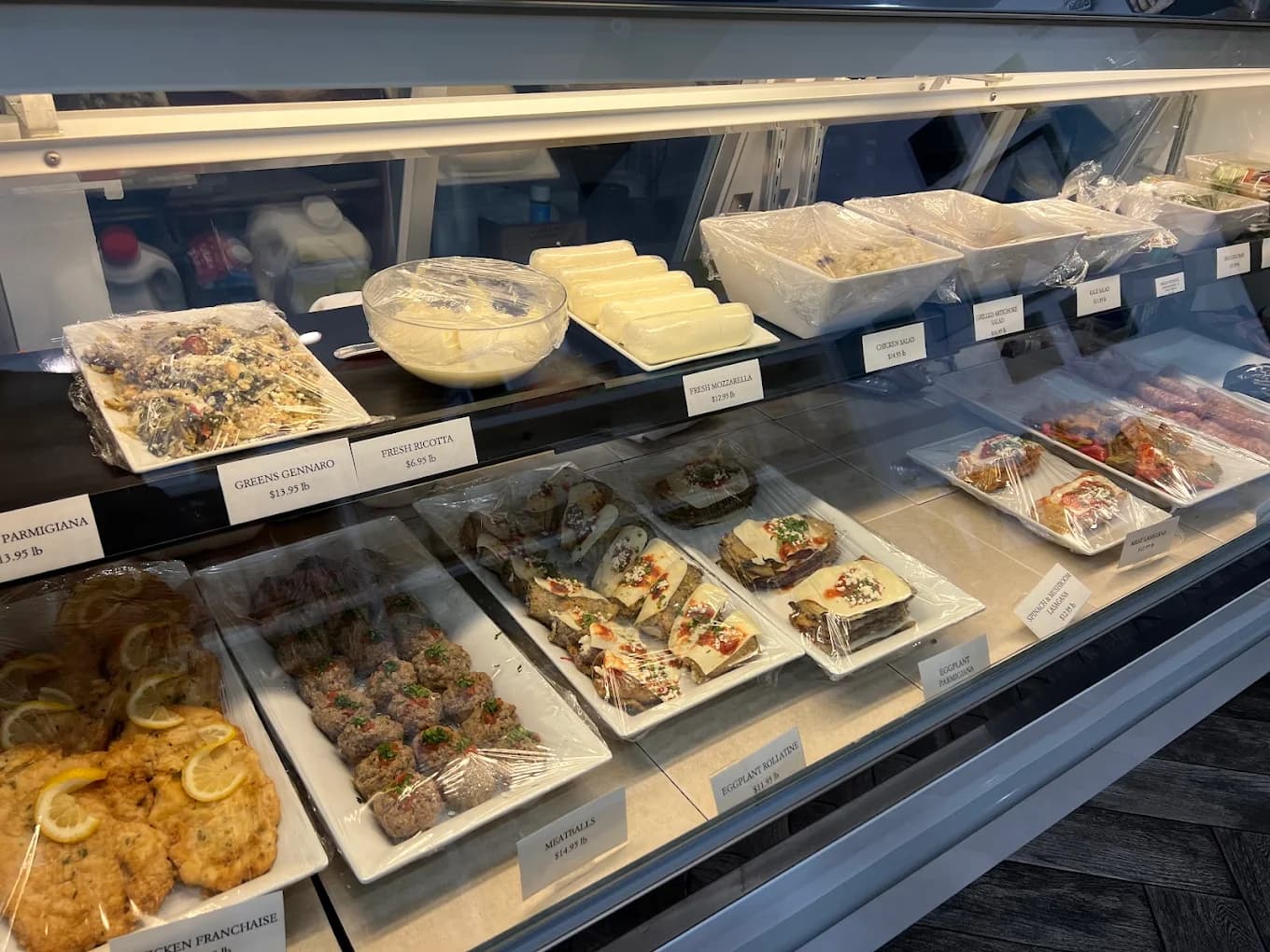 Inside the Mercato kitchen — display case of prepared dishes