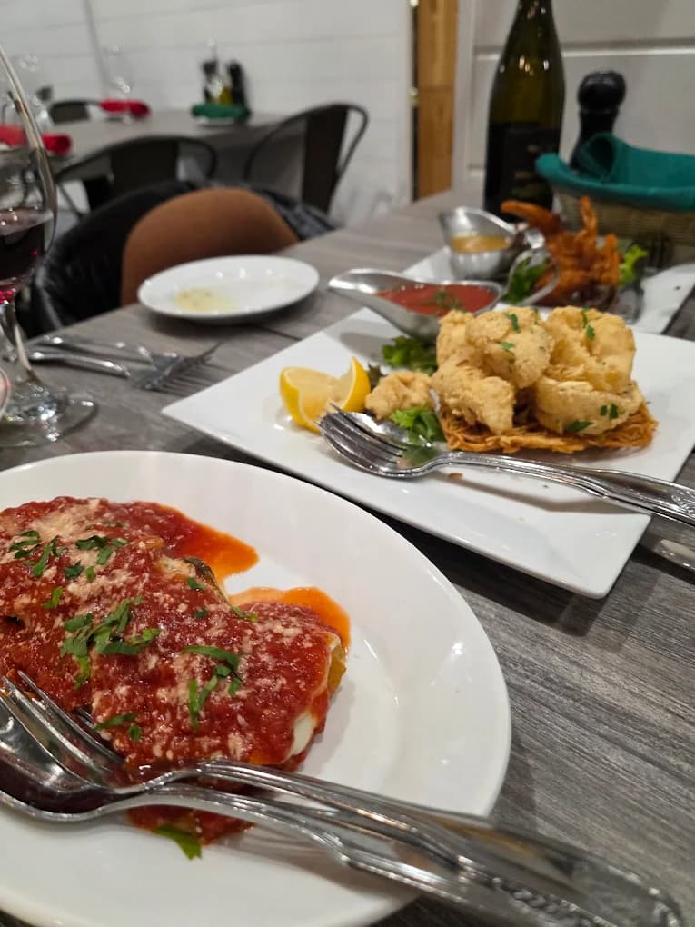 Plated chicken parmigiana and fried calamari