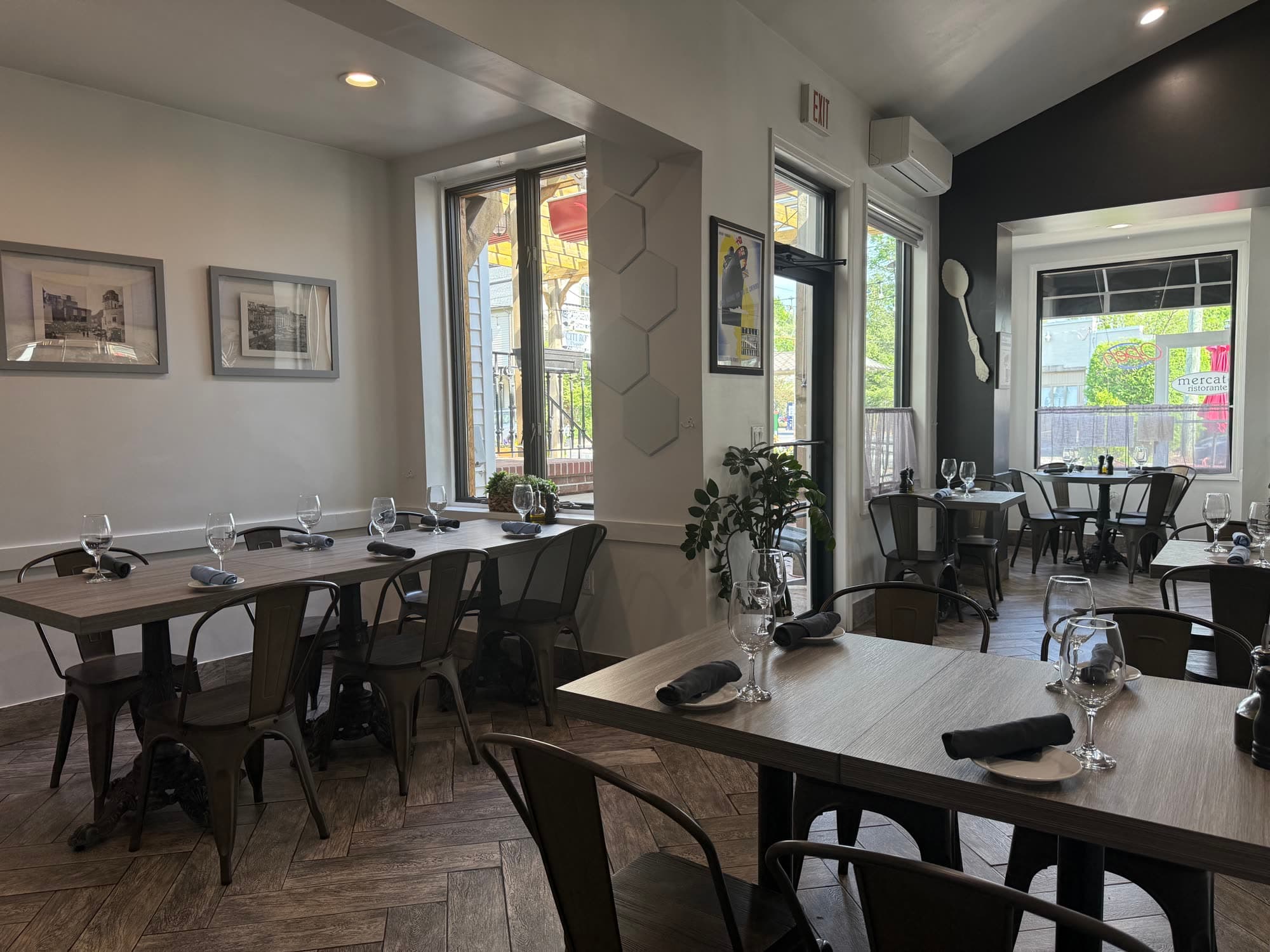 Mercato dining room — warm afternoon light with the storefront window visible
